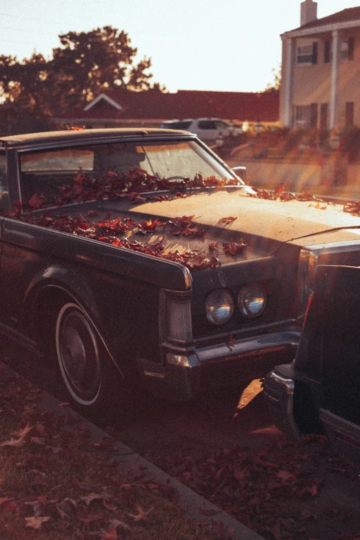 an old fashioned black car is parked in the driveway