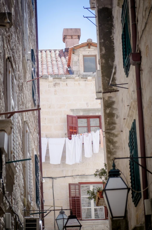 some windows and clothes line on a brick building