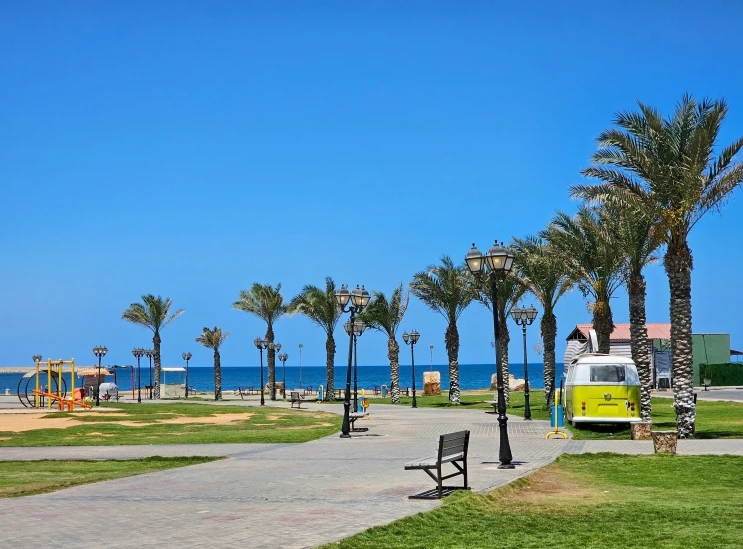 a person in a yellow and white van sits on a park bench