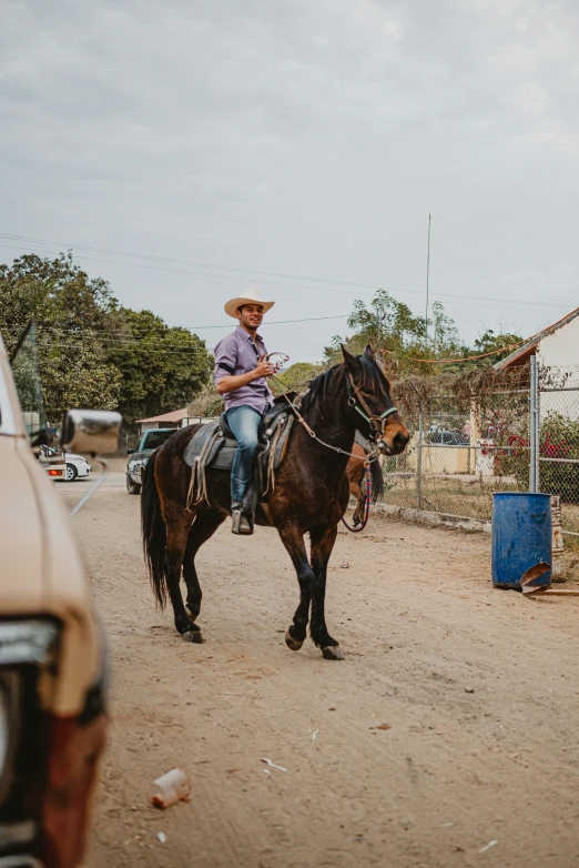 a man on a horse near a building