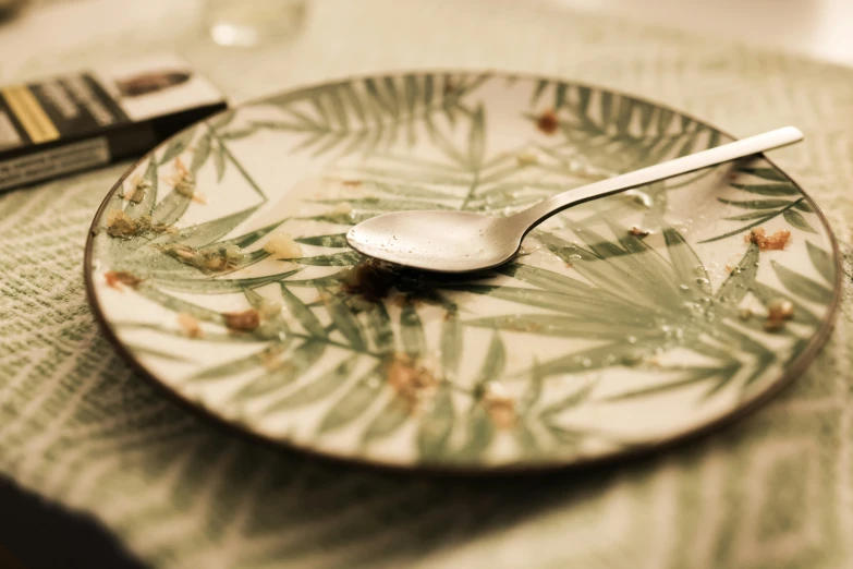 a white plate with a spoon on it