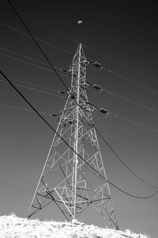 an electric tower with power lines overhead