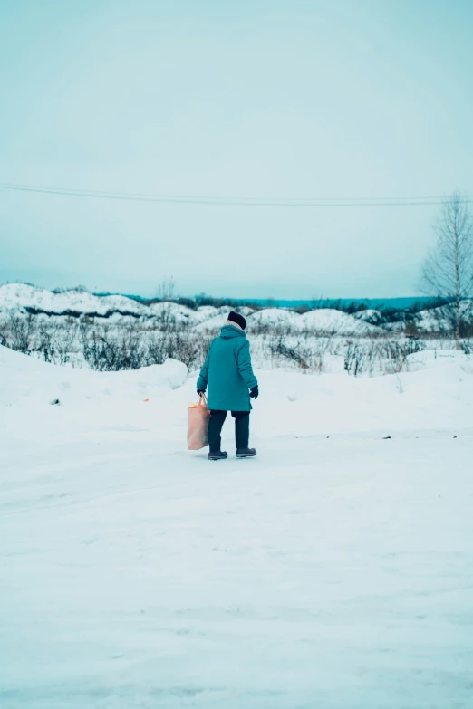 man with snowboard next to small river during winter