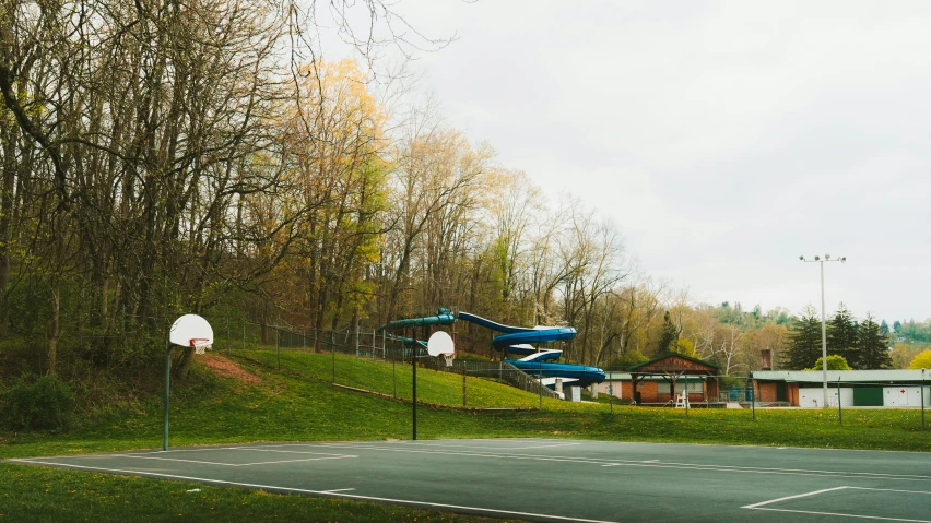 two basketball courts with different kind of games on the hill