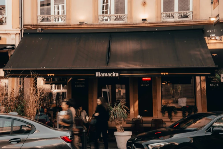 cars parked outside the front entrance to a restaurant