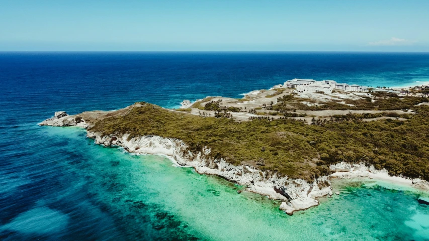 the island is surrounded by clear blue water