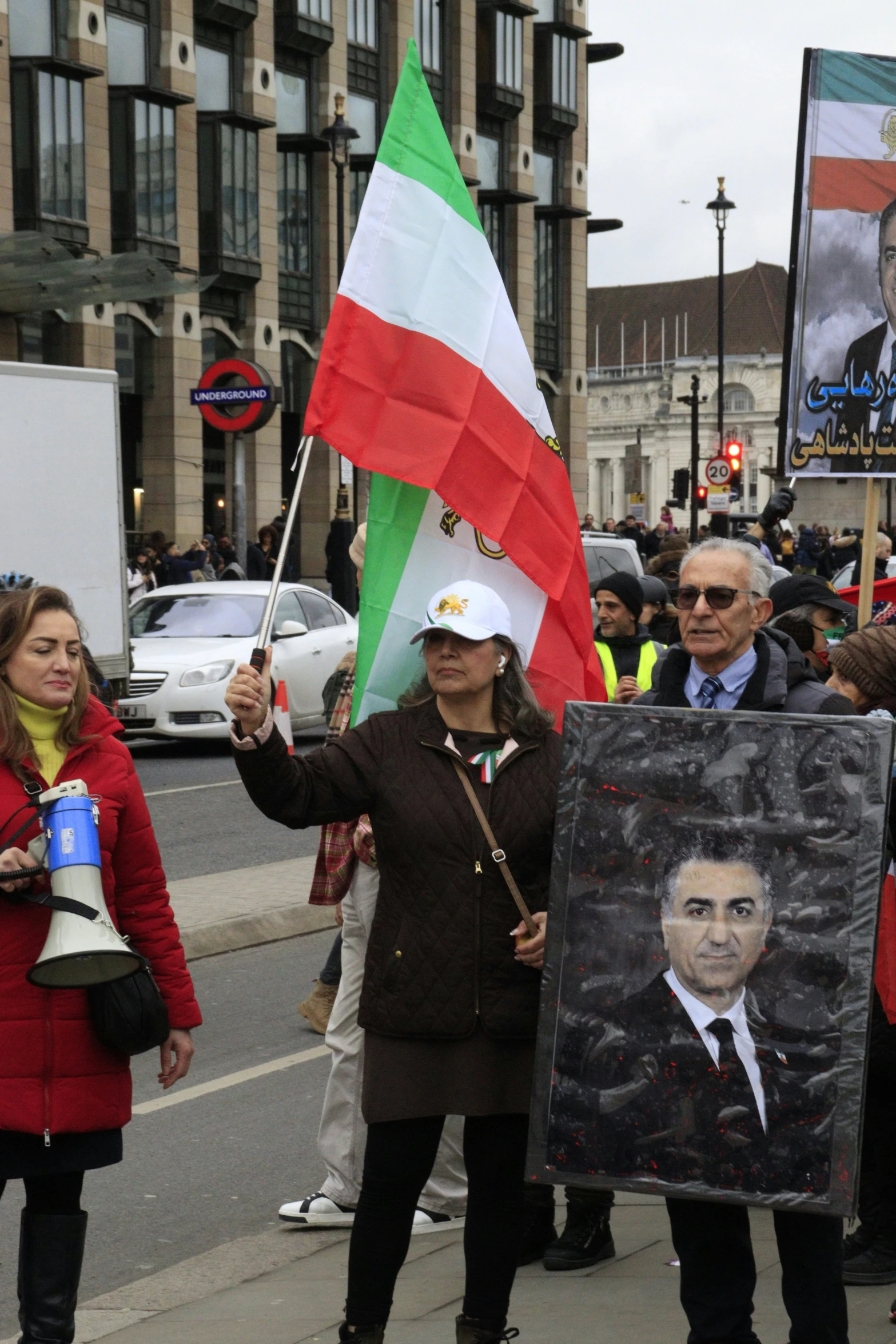 a crowd of people that are standing up holding signs