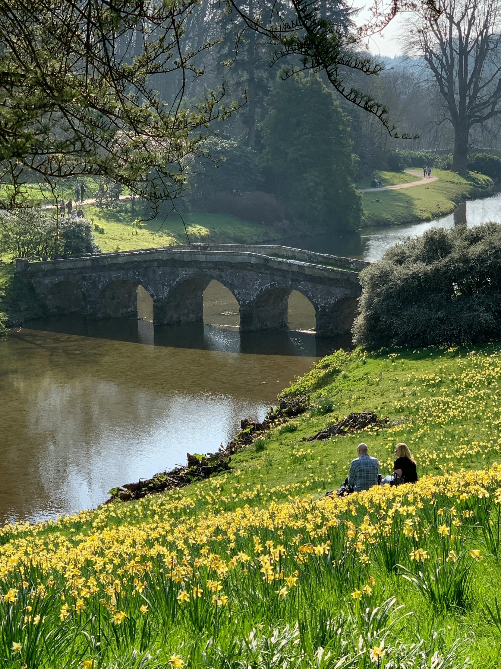 two people are relaxing by the water