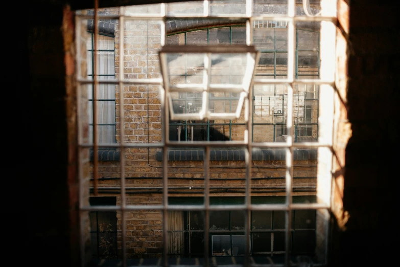 a picture taken through a window of a large brick building