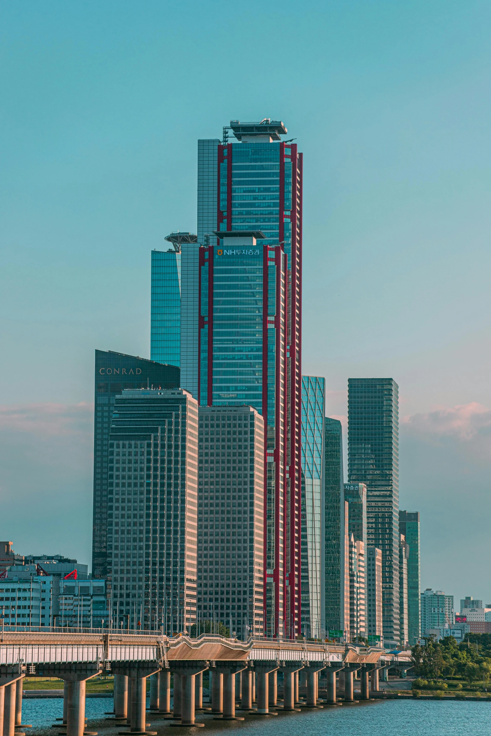 tall city buildings overlooking the river in the daytime