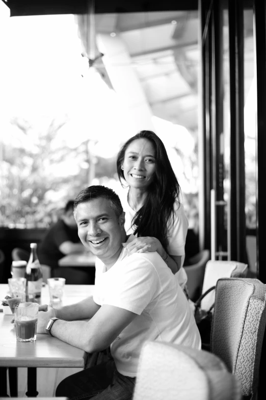 a man sitting next to a woman at a table