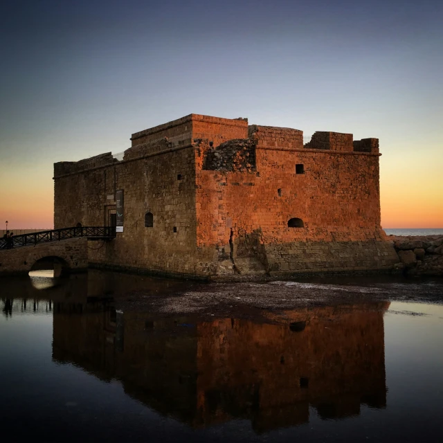 a castle built on a island with a bridge in the middle