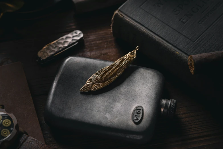 a cigarette lighter is next to two antique book