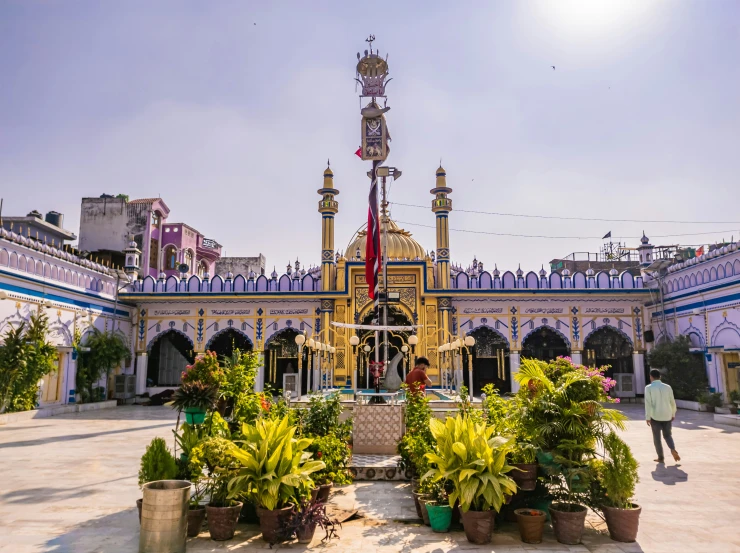 a yellow building with several flags at the top