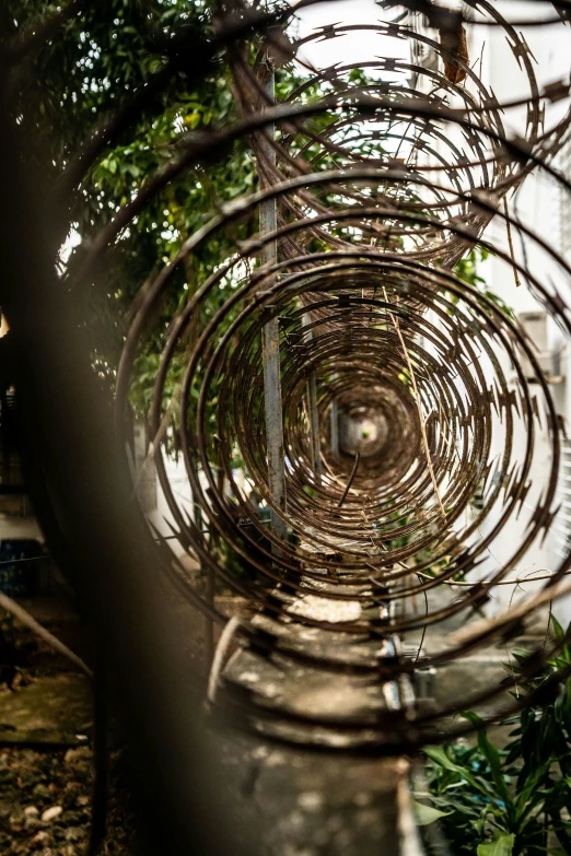 a large metal ball with a tree in the middle