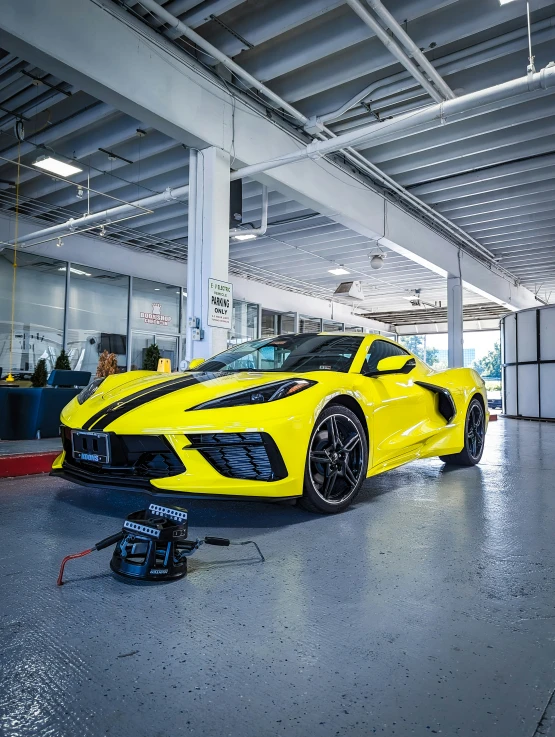 an automobile is sitting in the garage and the car is on display