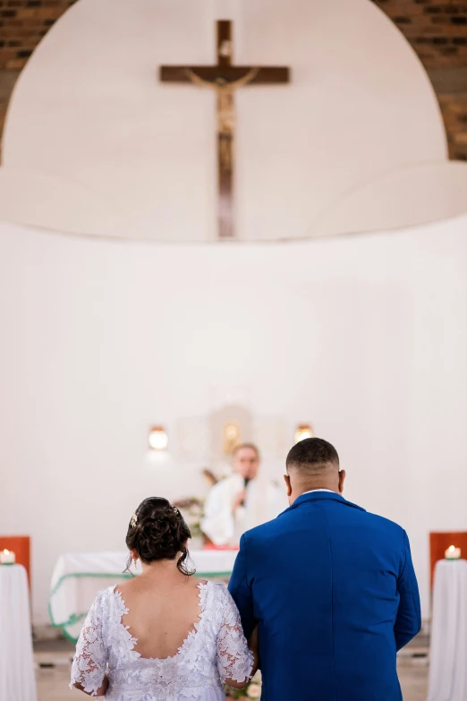 a bride and groom walk down the aisle