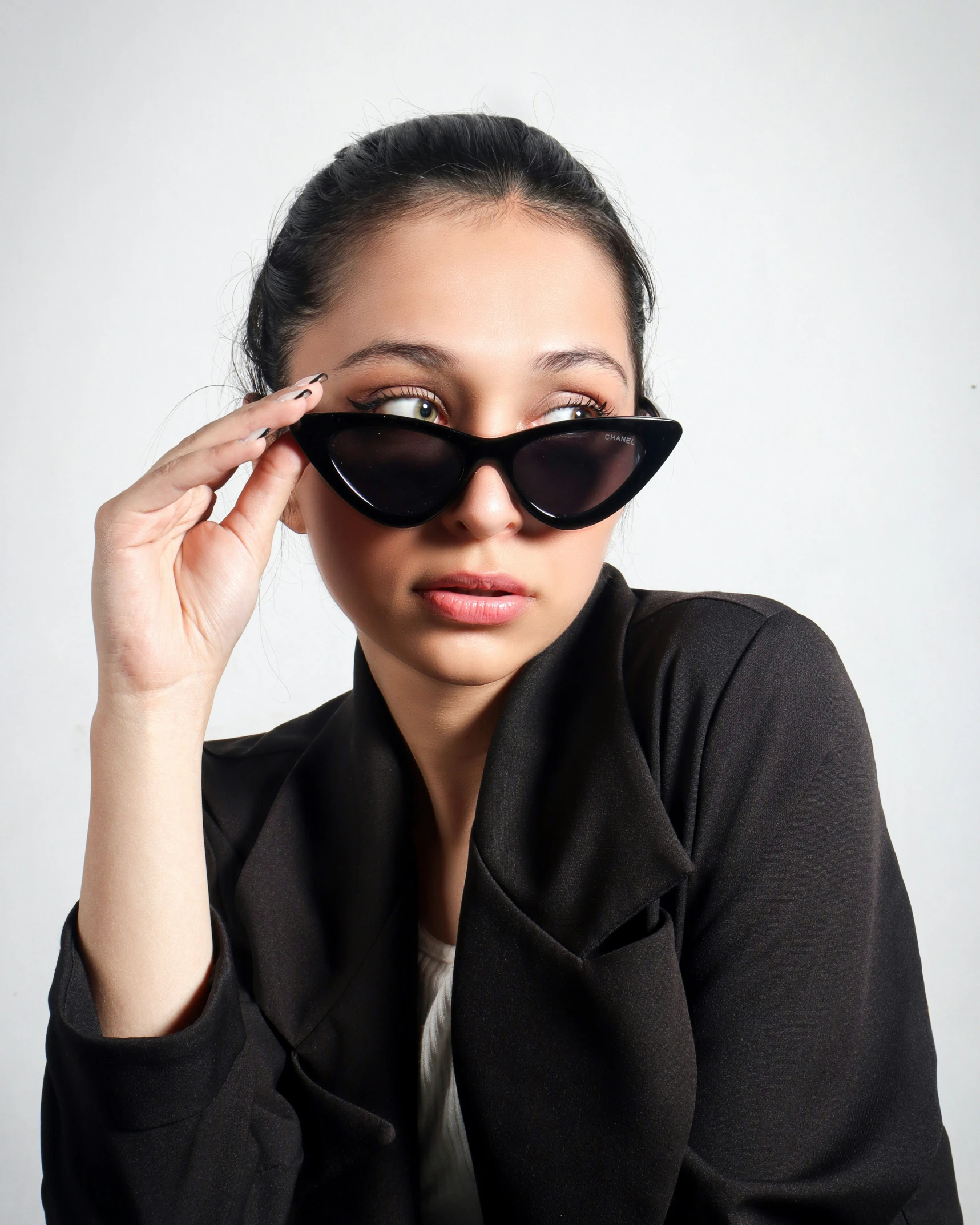 a woman wearing sunglasses is looking in the mirror