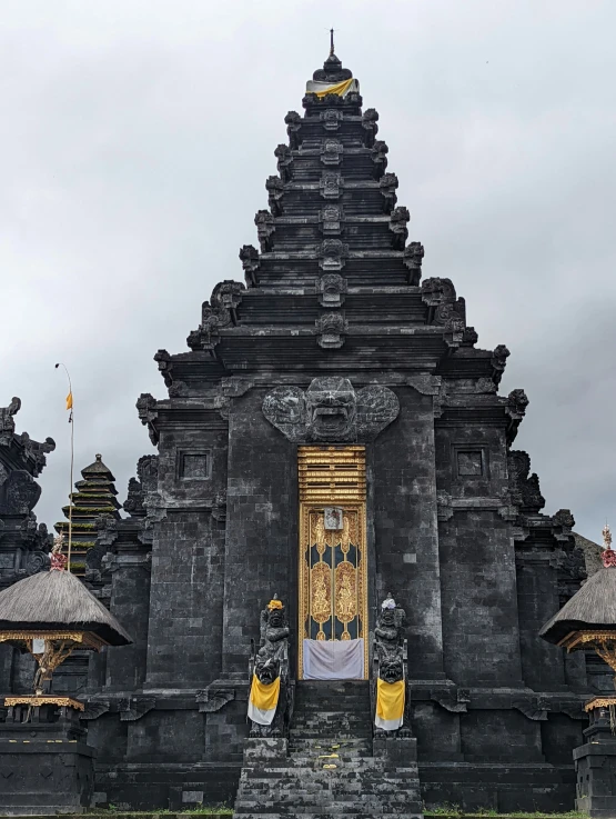 black painted wooden structure with decorations and door