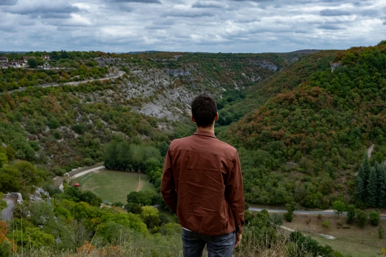 a man is looking out at the valley below