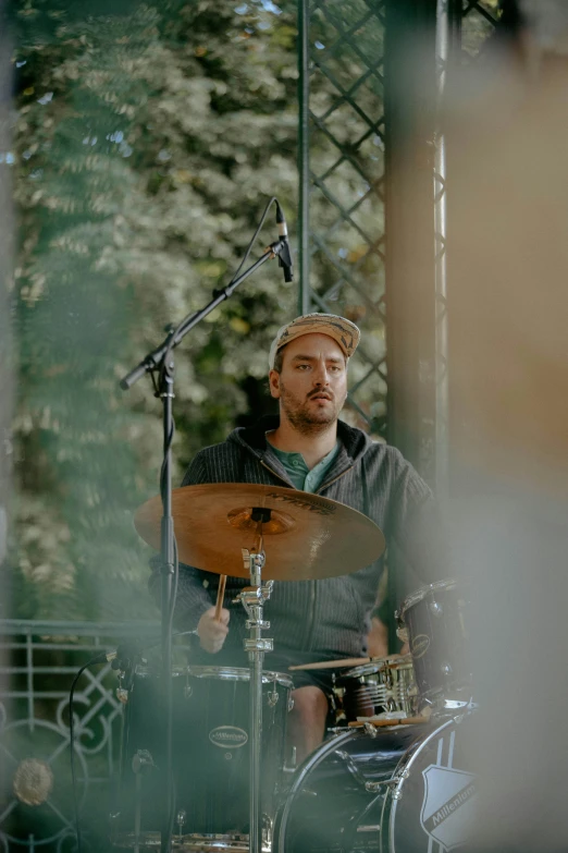 there is a man playing a drum on stage