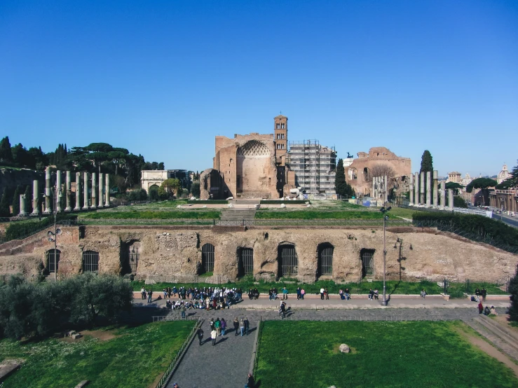 an ancient building with columns, and a tower on top of it