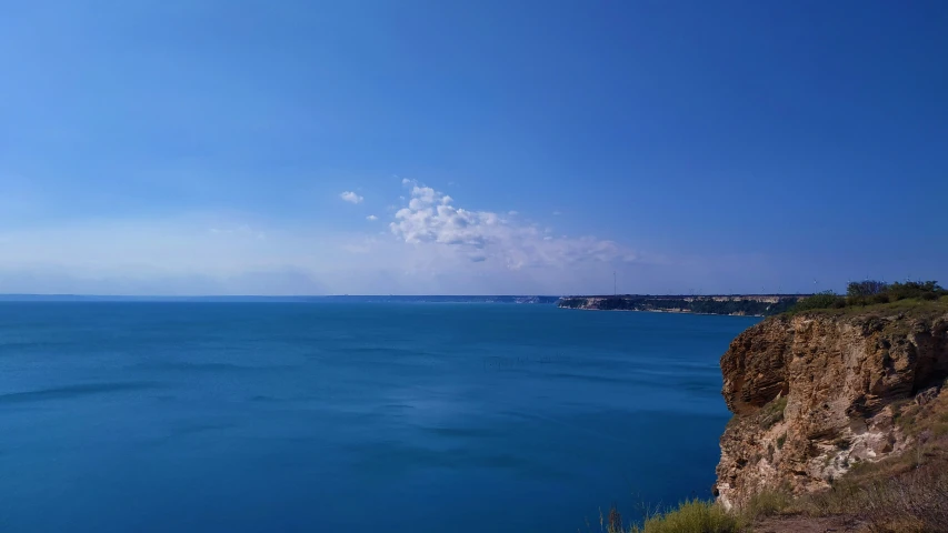 blue sky over the ocean next to the beach