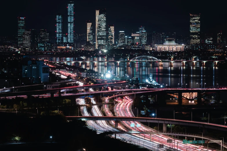 city lights and long lines of traffic are overpassing an interstate