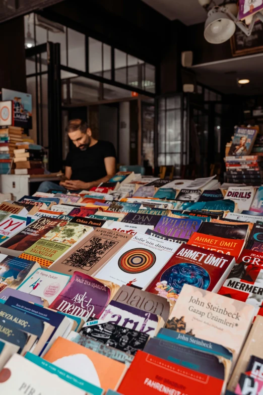 many books stacked up on top of one another