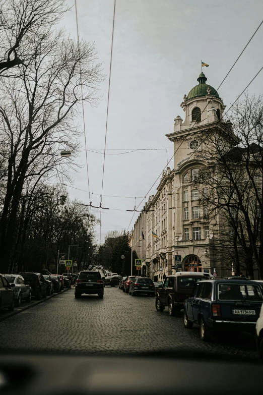 cars are parked at an intersection in a small village