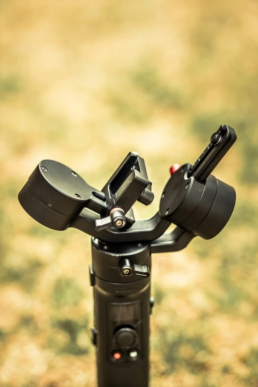 close up of tripod housing in open grassy area