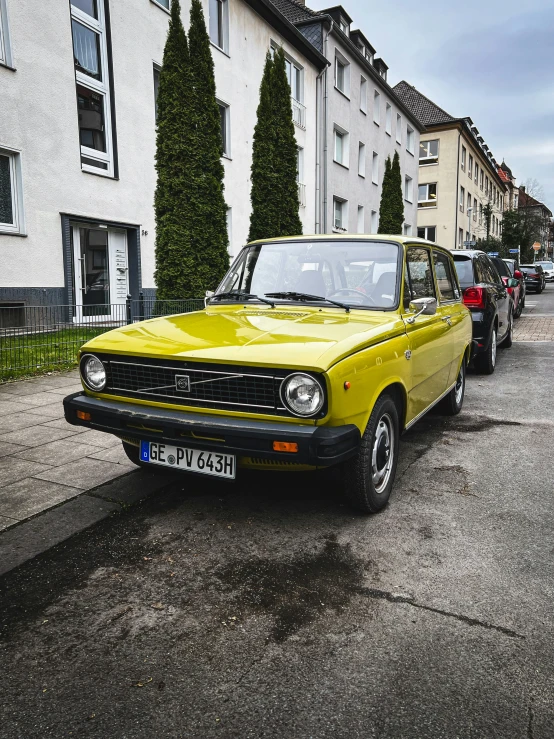 an old school car sitting in a row on the street