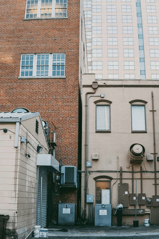 the back of several brown brick buildings with some windows