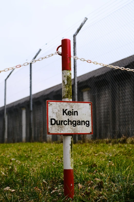 a warning sign on the fence with chain linked