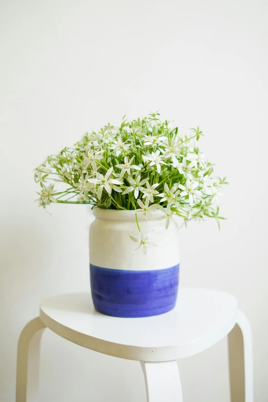 a blue and white vase sitting on top of a table