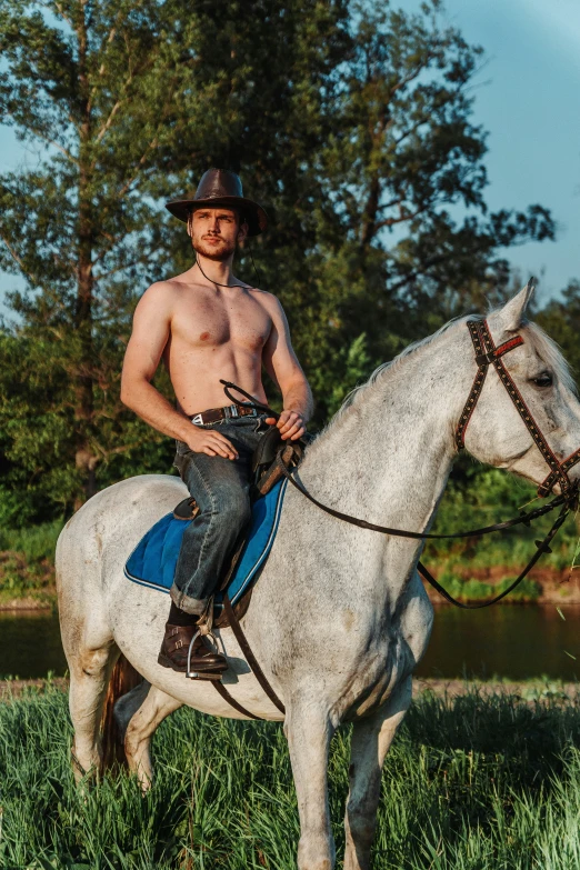 a man on a horse posing for the camera