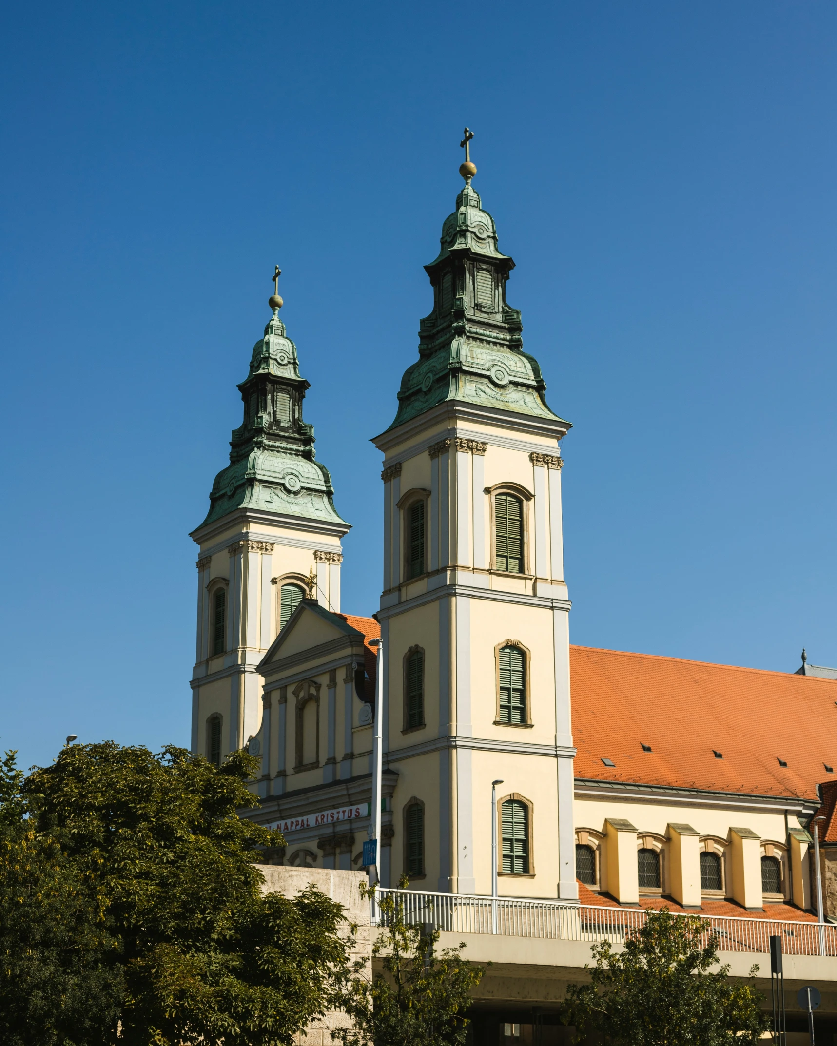 a tall building with two towers with a clock on top