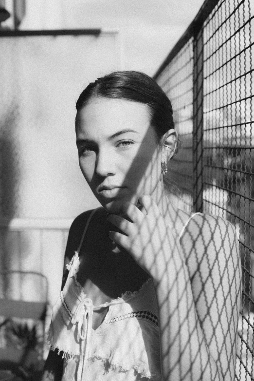 a person is looking at a camera while inside of a cage