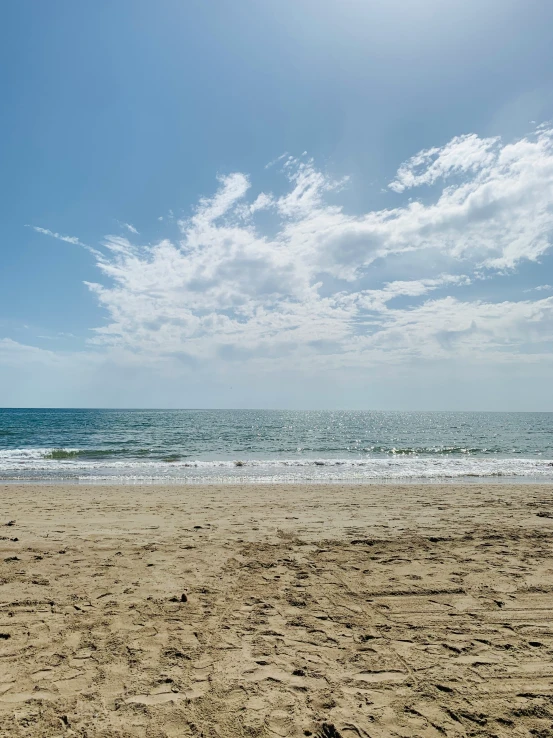 a person on a beach is throwing a frisbee