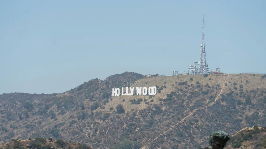 the famous hollywood sign is nestled high up on the top of a mountain