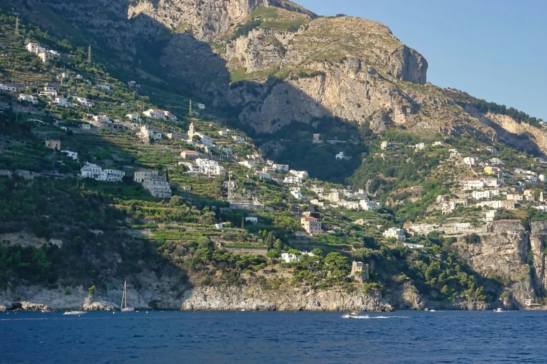 a scenic view of the city sits on a mountain overlooking a body of water