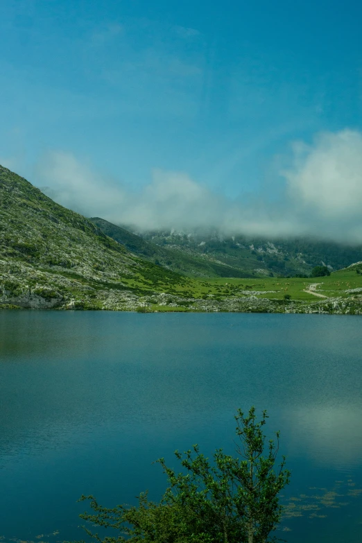 a lake is pictured in the middle of a mountain