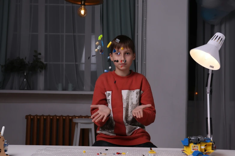 a person sitting in front of a table with legos