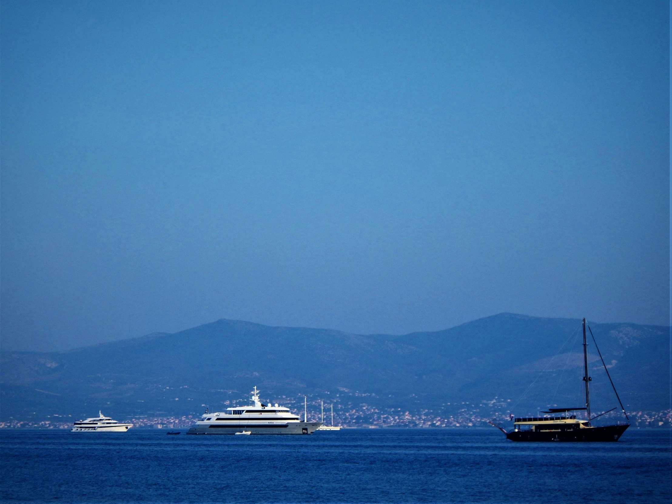 two boats on the water near some mountains