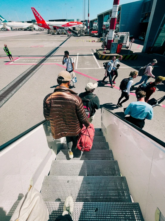 passengers on a flight deck with luggage sitting under them