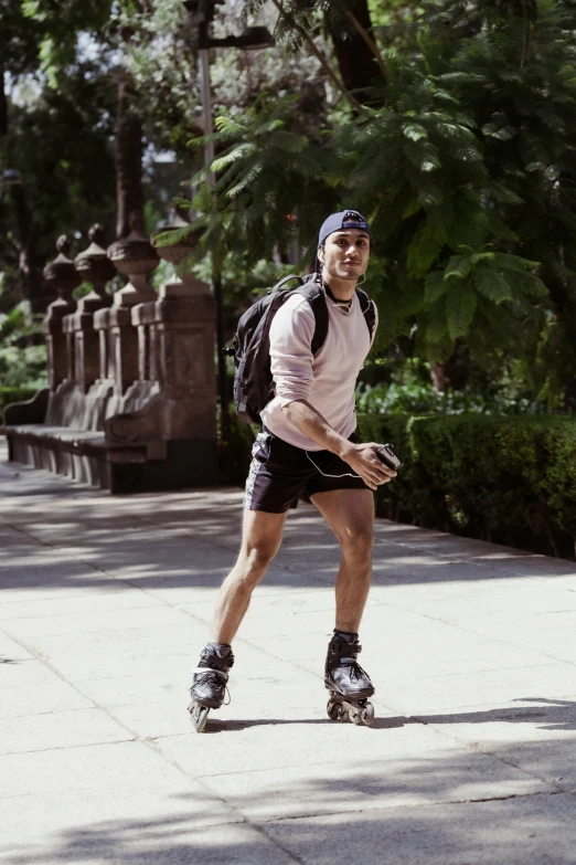 the young man rides his skateboard and is smiling