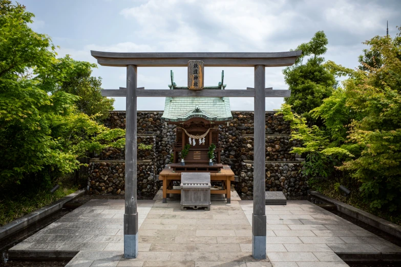 a stone garden patio with a table and bench