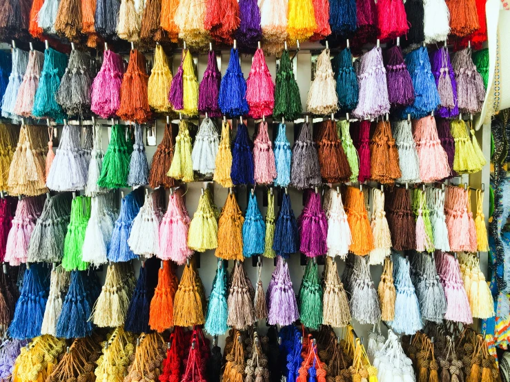 the wall is full of different colored tassels