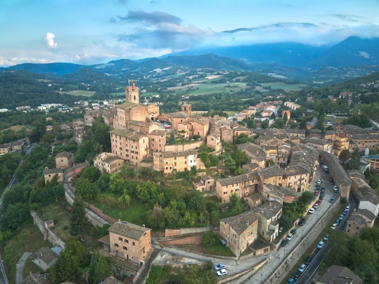 an old town with a steep mountain range in the background