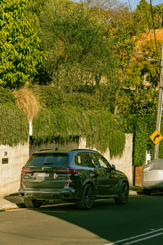 a black suv parked on the side of the road